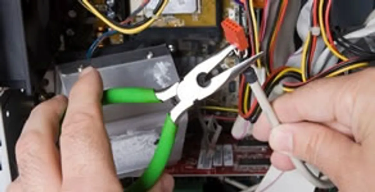 Licensed electrical contractor performing electrical repair with tools in Cortez, FL